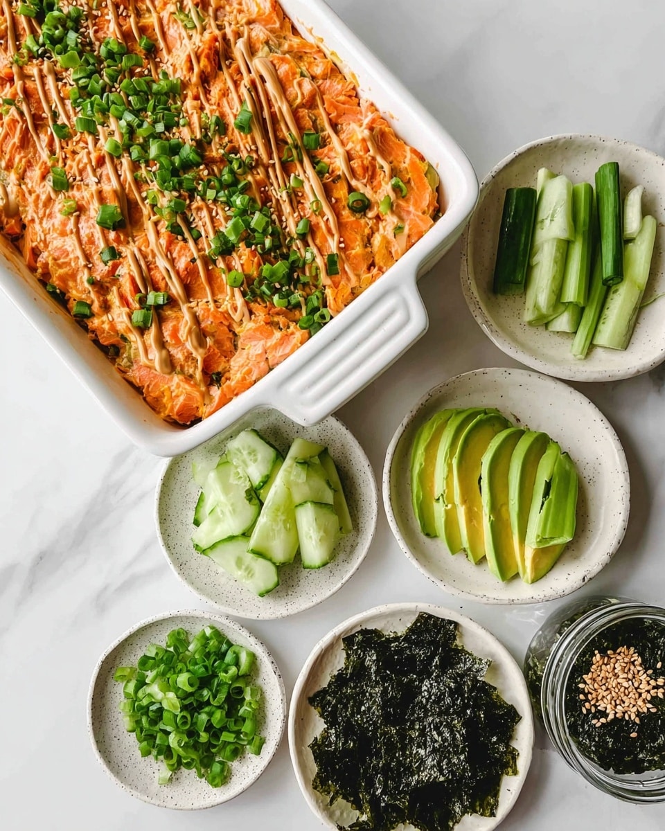 A white rectangular baking dish filled with a creamy orange-pink baked salmon mixture topped with light brown drizzles of sauce and sprinkled with fresh green chopped scallions. To the left of the dish on a white marbled surface, there are five small white speckled plates holding different ingredients: long thin slices of light and dark green cucumber and green onion, shiny dark green rectangular seaweed sheets, chopped bright green scallions, thinly sliced bright green avocado fanned out neatly, and a small container of dark green seaweed with white sesame seeds. Photo taken with an iphone --ar 4:5 --v 7