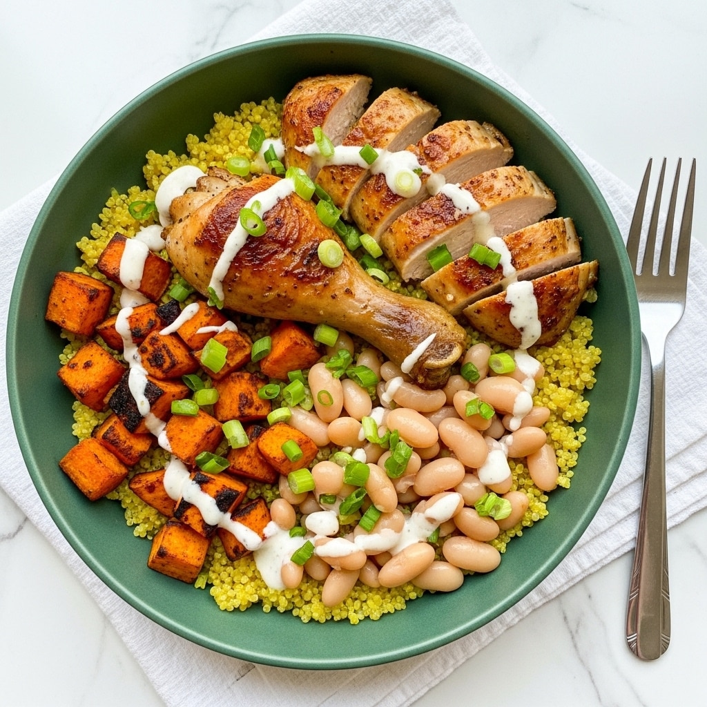 A light green bowl filled with four main layers starts with a base of fluffy, pale yellow quinoa covering the bottom. On one side, a browned chicken drumstick with roasted texture sits on top of the quinoa, with sliced grilled chicken pieces placed near it, all drizzled with a creamy white sauce and sprinkled with chopped green onions. Next to the chicken, there are soft, smooth white beans grouped together with some sauce and green onion on top. On the opposite side, bright orange roasted sweet potato cubes with some charred edges are also drizzled with the same white sauce and garnished with green onion pieces. The bowl rests on a white cloth napkin on top of a white marbled surface with a silver fork beside it. Photo taken with an iphone --ar 4:5 --v 7