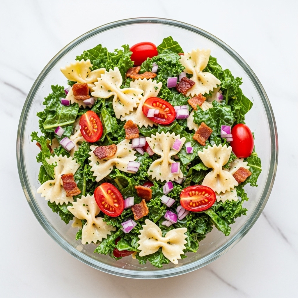 A clear glass bowl filled with a colorful pasta salad sits on a white marbled surface. The salad has three main layers: light yellow bowtie pasta scattered throughout, fresh green leafy kale mixed evenly, and bright red grape tomatoes cut in half. Topping the salad are small pieces of crispy brown bacon and finely chopped purple onions. A creamy white dressing is lightly drizzled over the whole salad, adding a glossy texture. In the background, vine-ripened red tomatoes rest on the white marbled surface. photo taken with an iphone --ar 4:5 --v 7