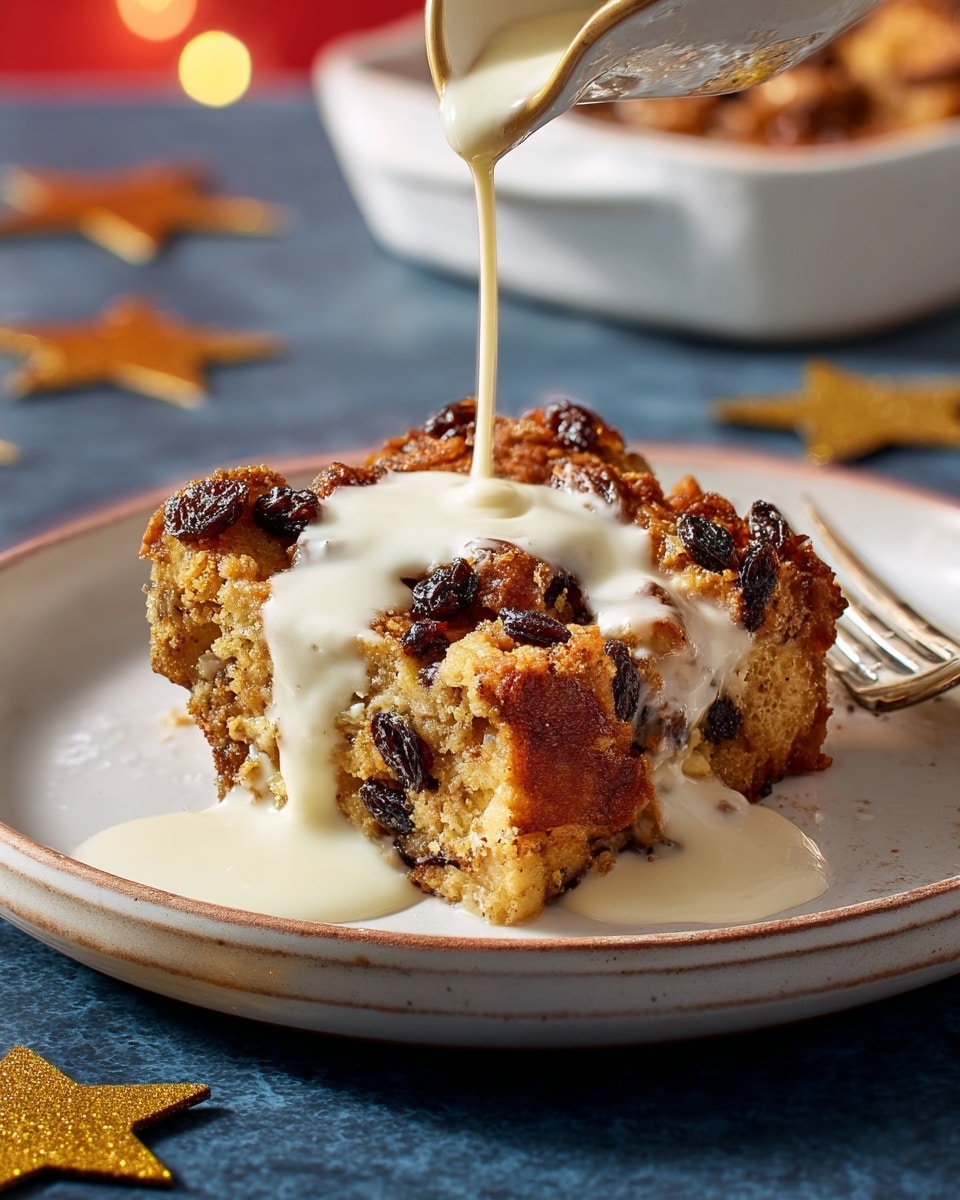 A slice of bread pudding with a golden-brown top layer dotted with dark raisins and a slightly crispy texture sits on a white plate with a blue inner surface that rests on a larger white plate with a darker blue inner surface. The pudding has a soft, moist yellowish interior showing pieces of bread and raisins embedded inside. Creamy white sauce is being poured from above, flowing over the top and sides of the pudding, pooling slightly on the plate. In the background, there is a blurred white bowl with a similar baked dish and a copper spoon on a white marbled surface, with golden star-shaped decorations nearby. Photo taken with an iphone --ar 4:5 --v 7