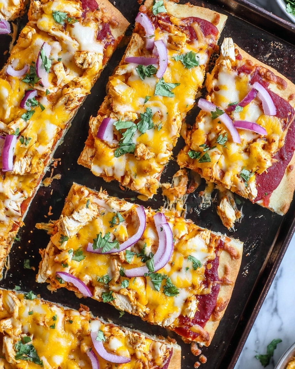 A close-up top view of six rectangular slices of pizza on a dark baking tray, each slice has three visible layers: a light golden brown crust base topped with a smooth red tomato sauce layer, then covered with melted yellow cheddar cheese with some white chunks of chicken scattered on top. Thin slices of purple-red onion and small green cilantro leaves are sprinkled across the pizza, adding color contrast. The slightly melted cheese creates a bubbly and textured surface, and there are a few crumbs and cheese bits around the edges of the baking tray, all set on a white marbled texture background. photo taken with an iphone --ar 4:5 --v 7